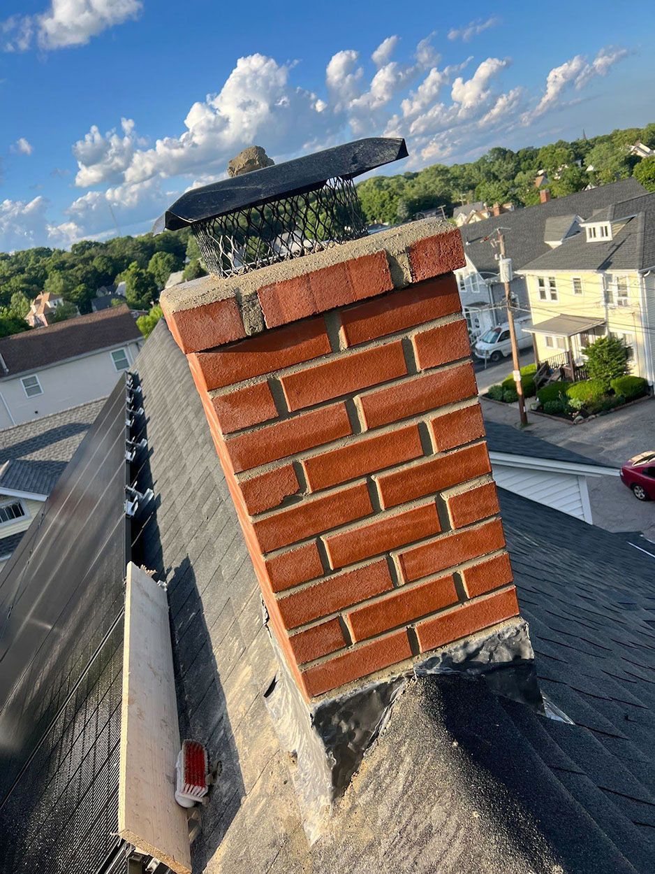 A new brick chimney on top of a roof