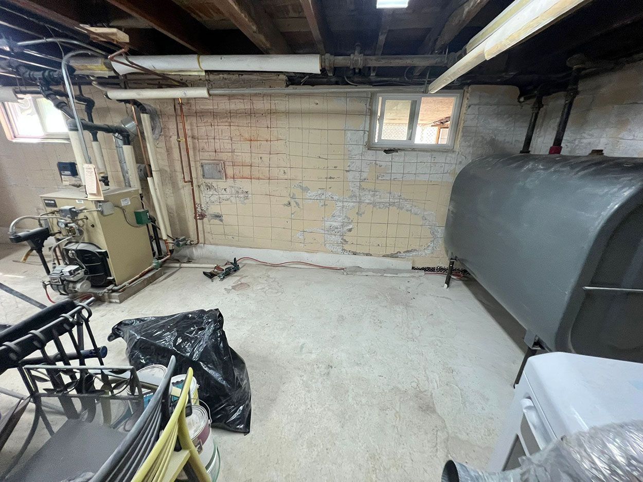 An old basement with a large tank and chairs