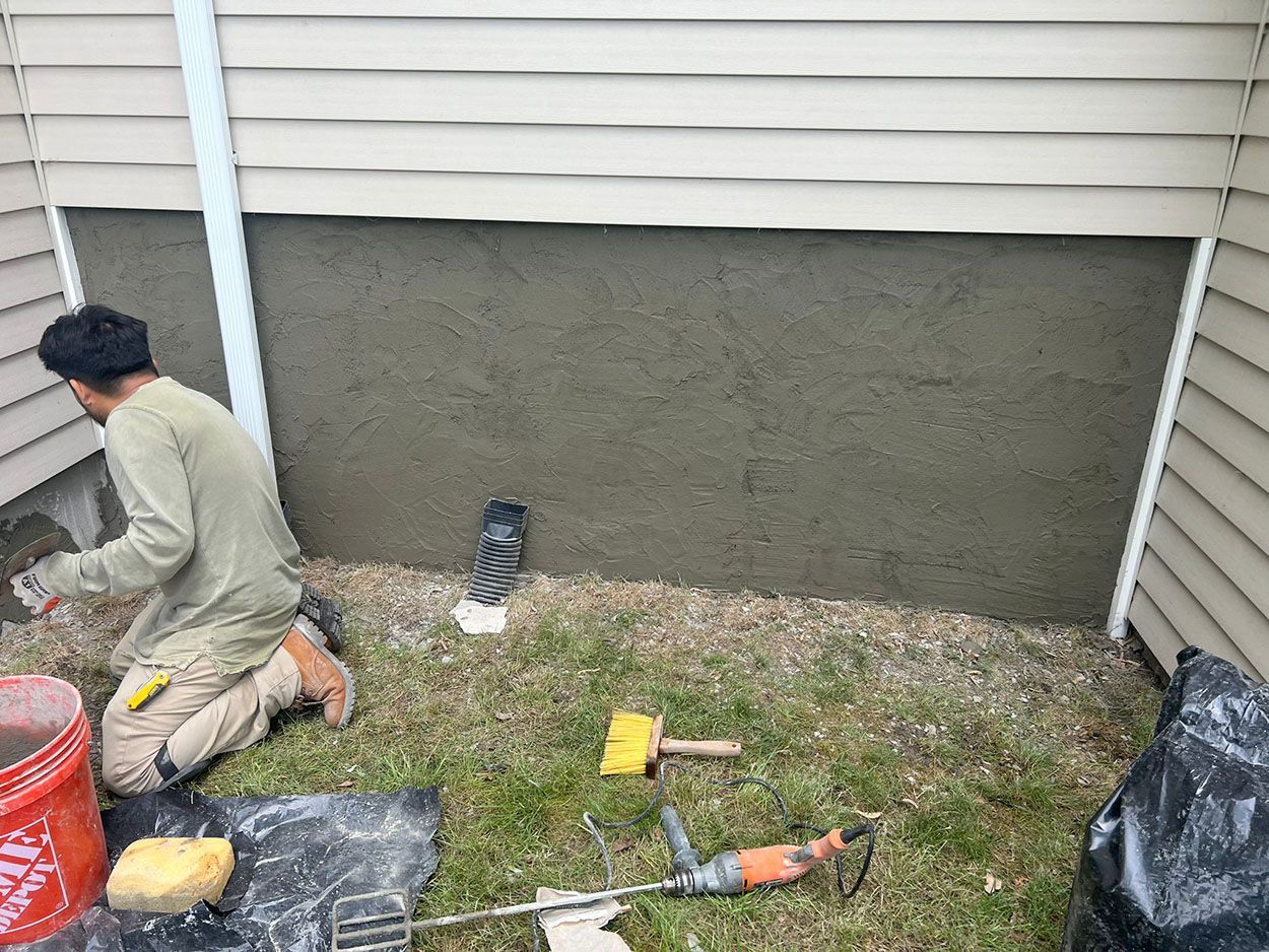 A man repairing a wall