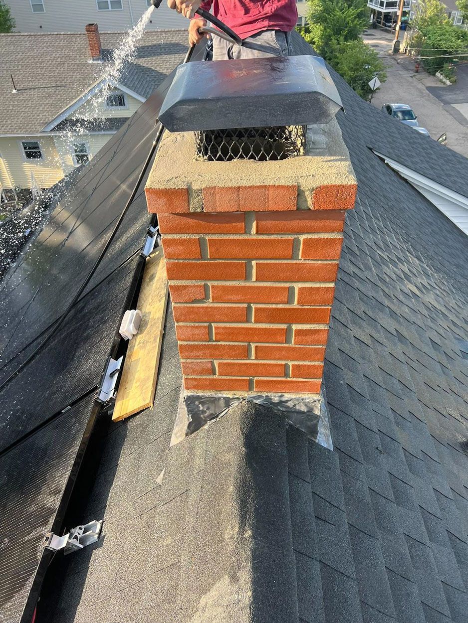 A repairing a brick chimney on a roof