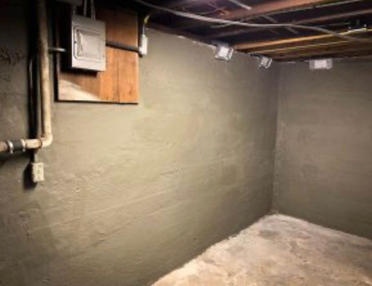 A basement with concrete walls and a concrete floor