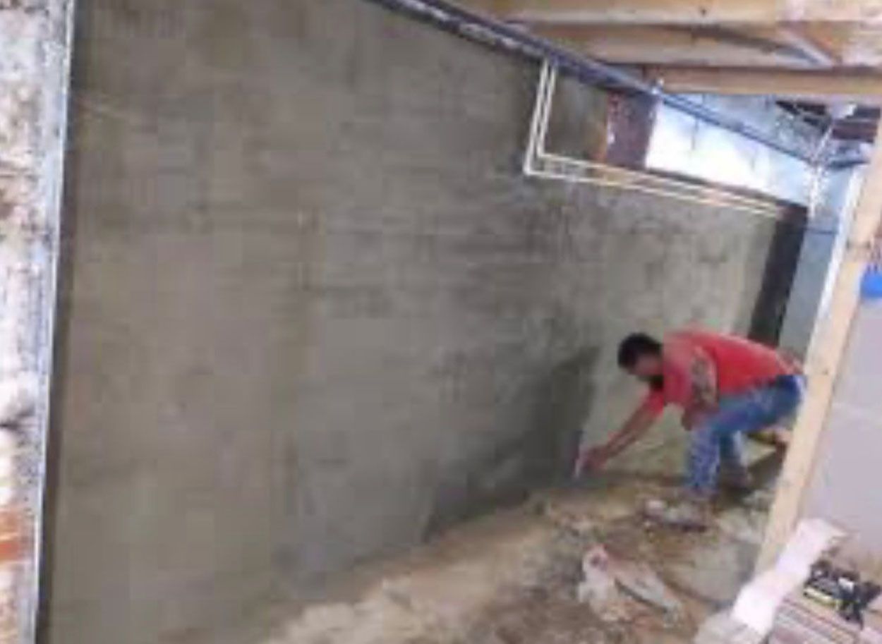 A man is working on a wall