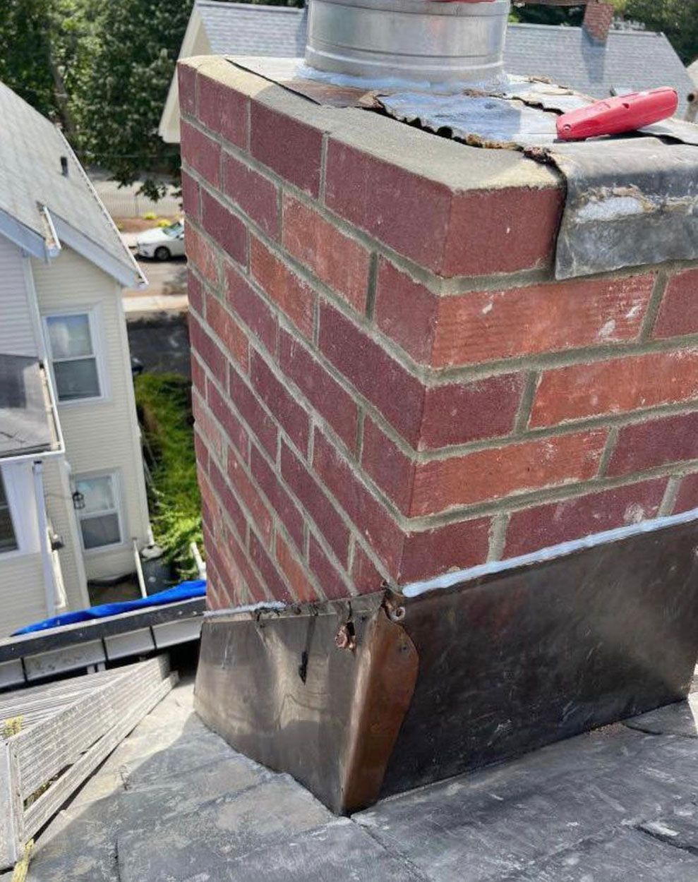 A brick chimney on top of a roof