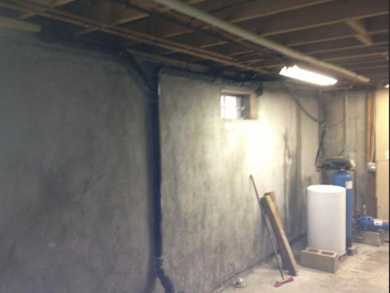 A basement with a water heater and a window