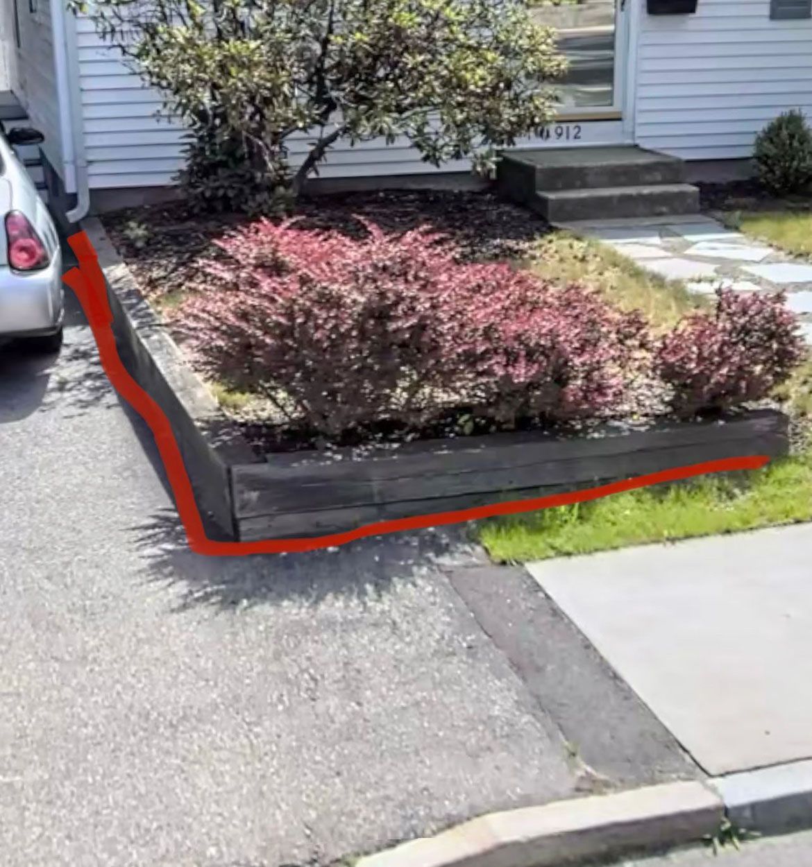 An old retaining wall in front of a house