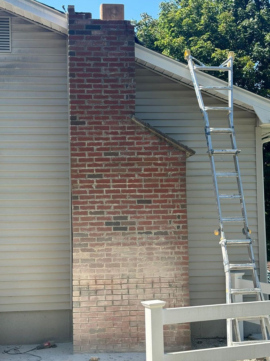 A brick chimney on the side of a house