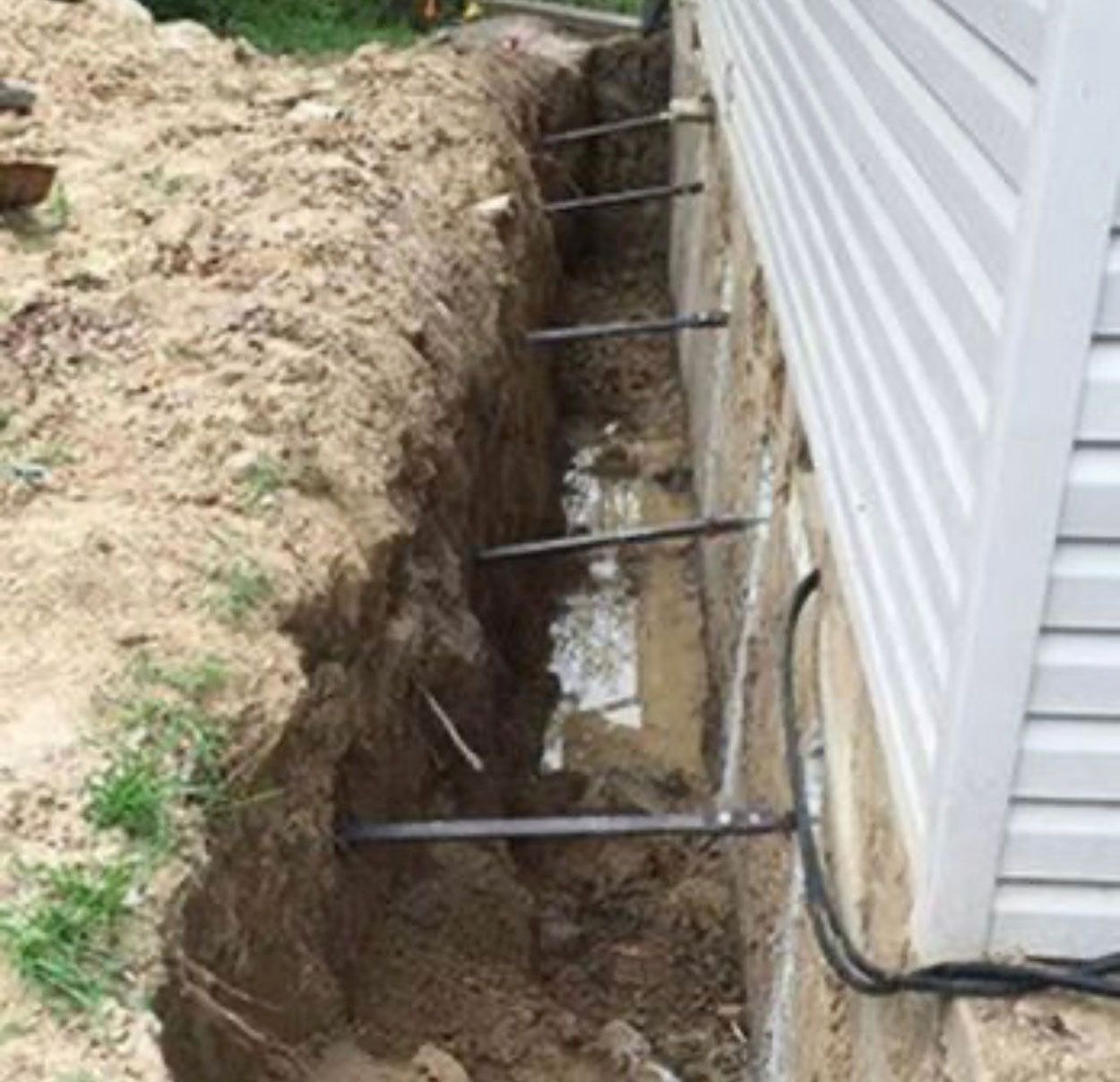 A large hole in the ground next to a house