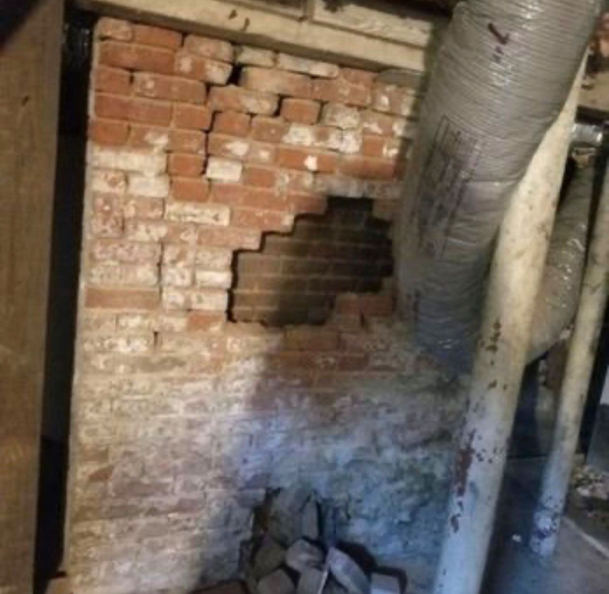 A brick wall with a hole in it