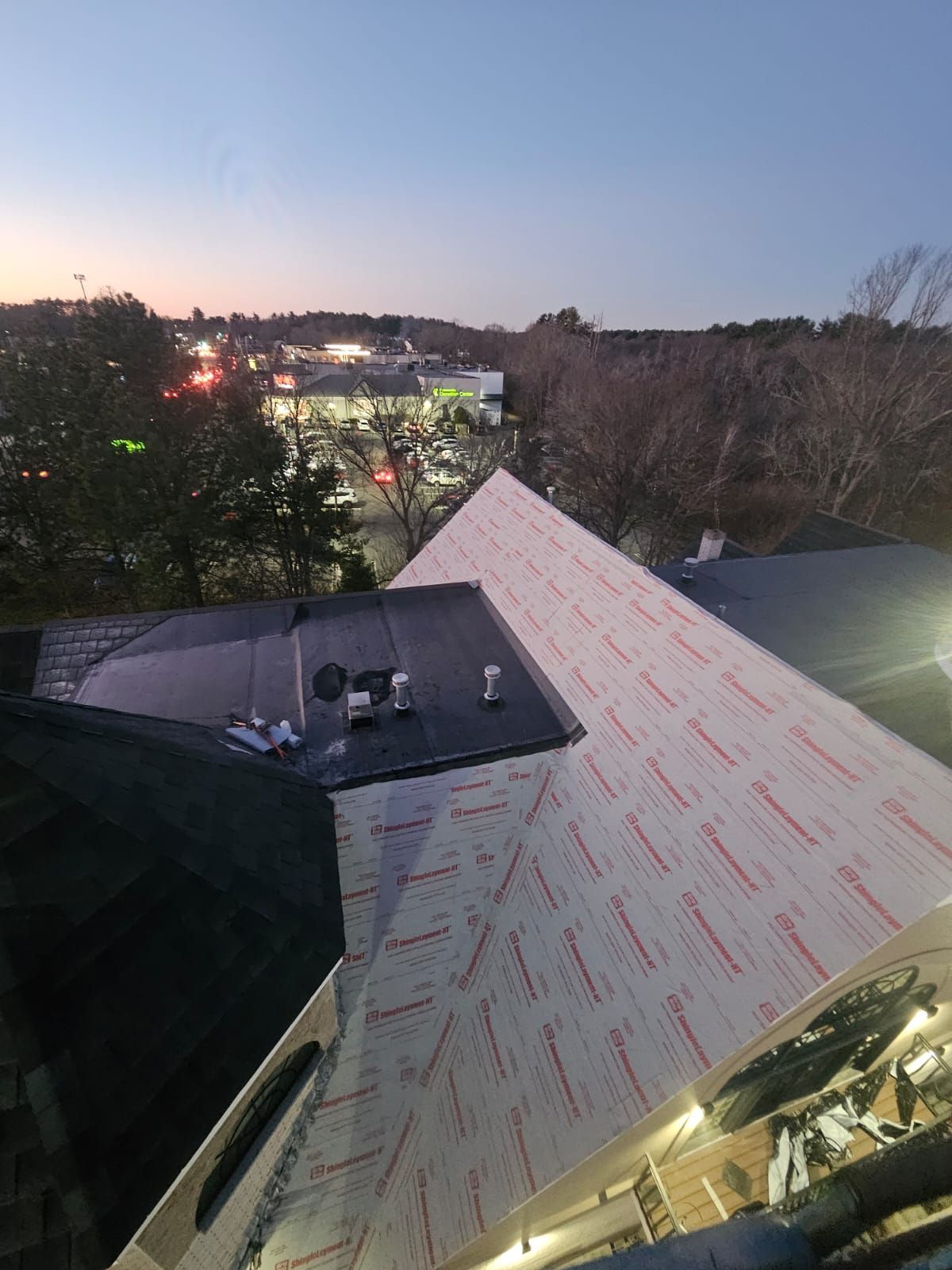 An aerial view of a roof with a city in the background.