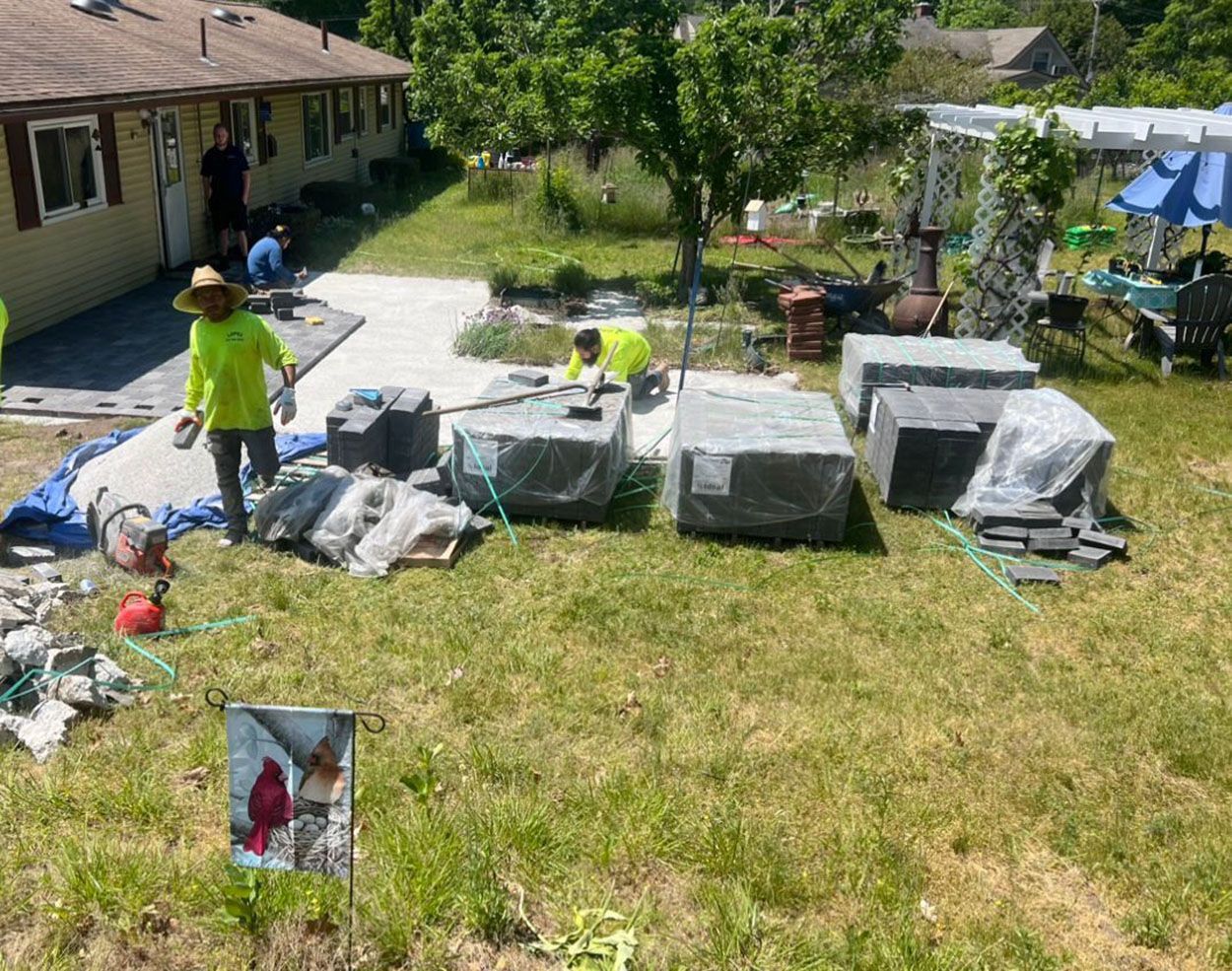 A group of people are working on a patio