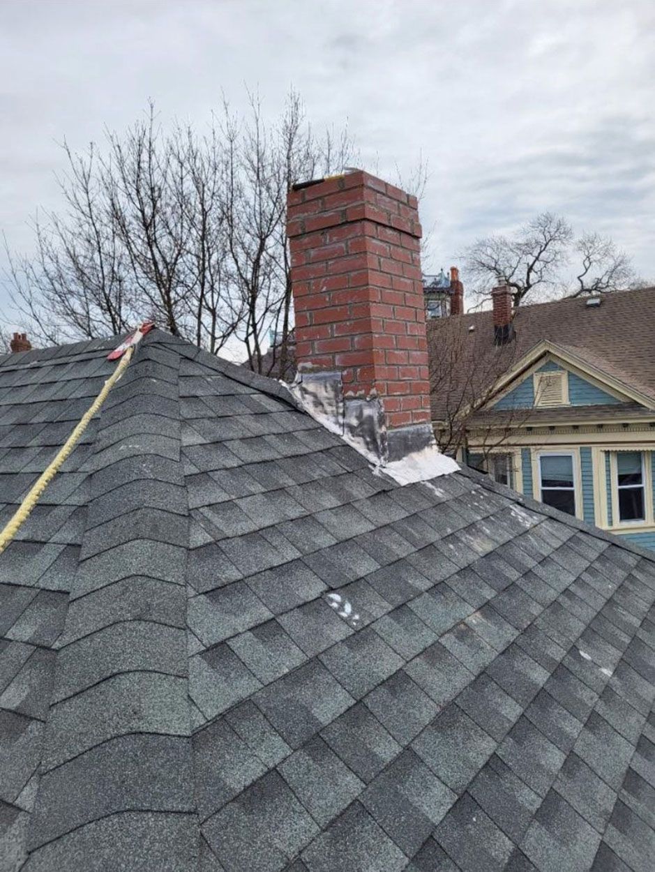 A roof with a brick chimney on top of it