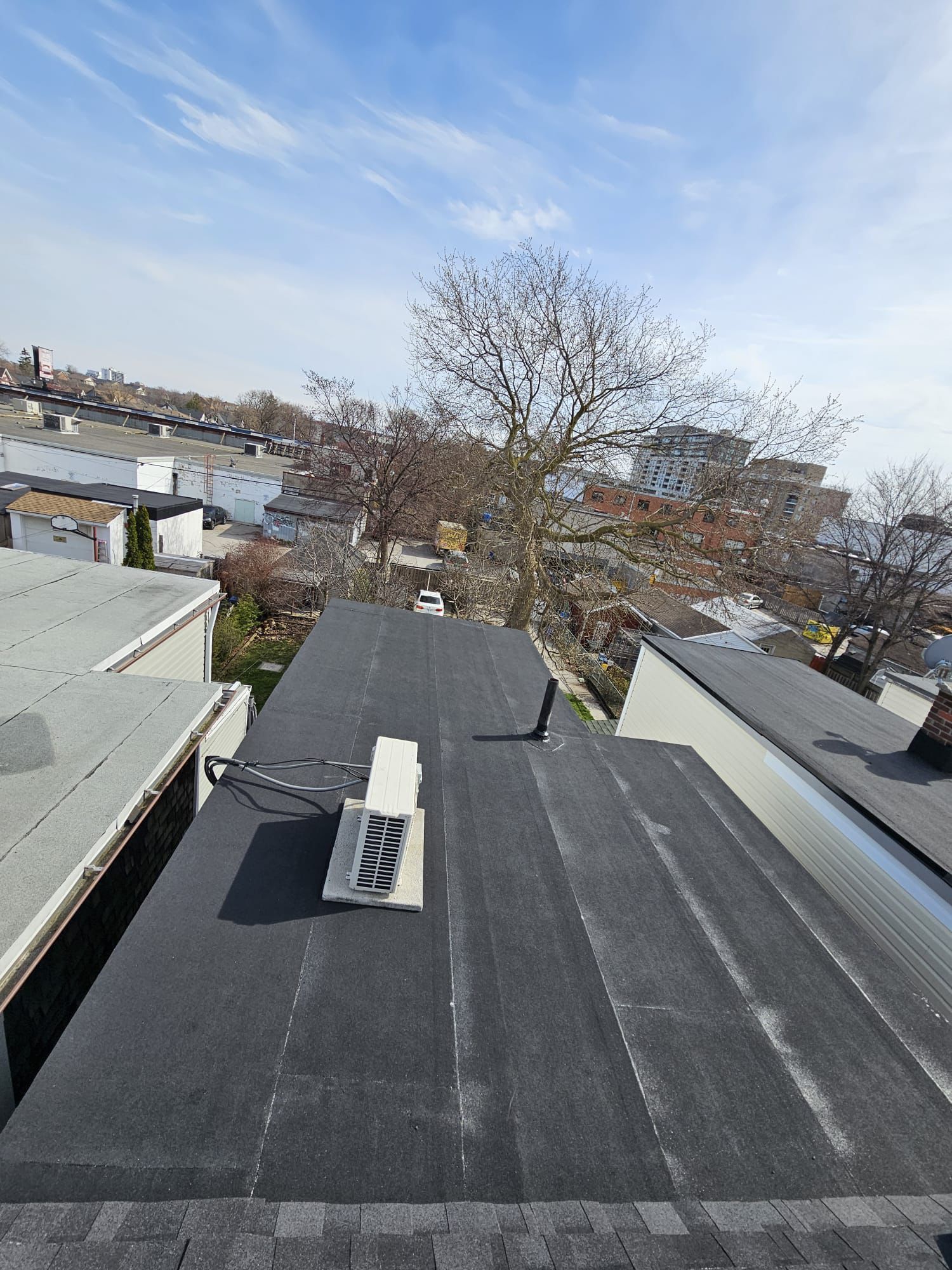 The roof of a house with a satellite dish on it.