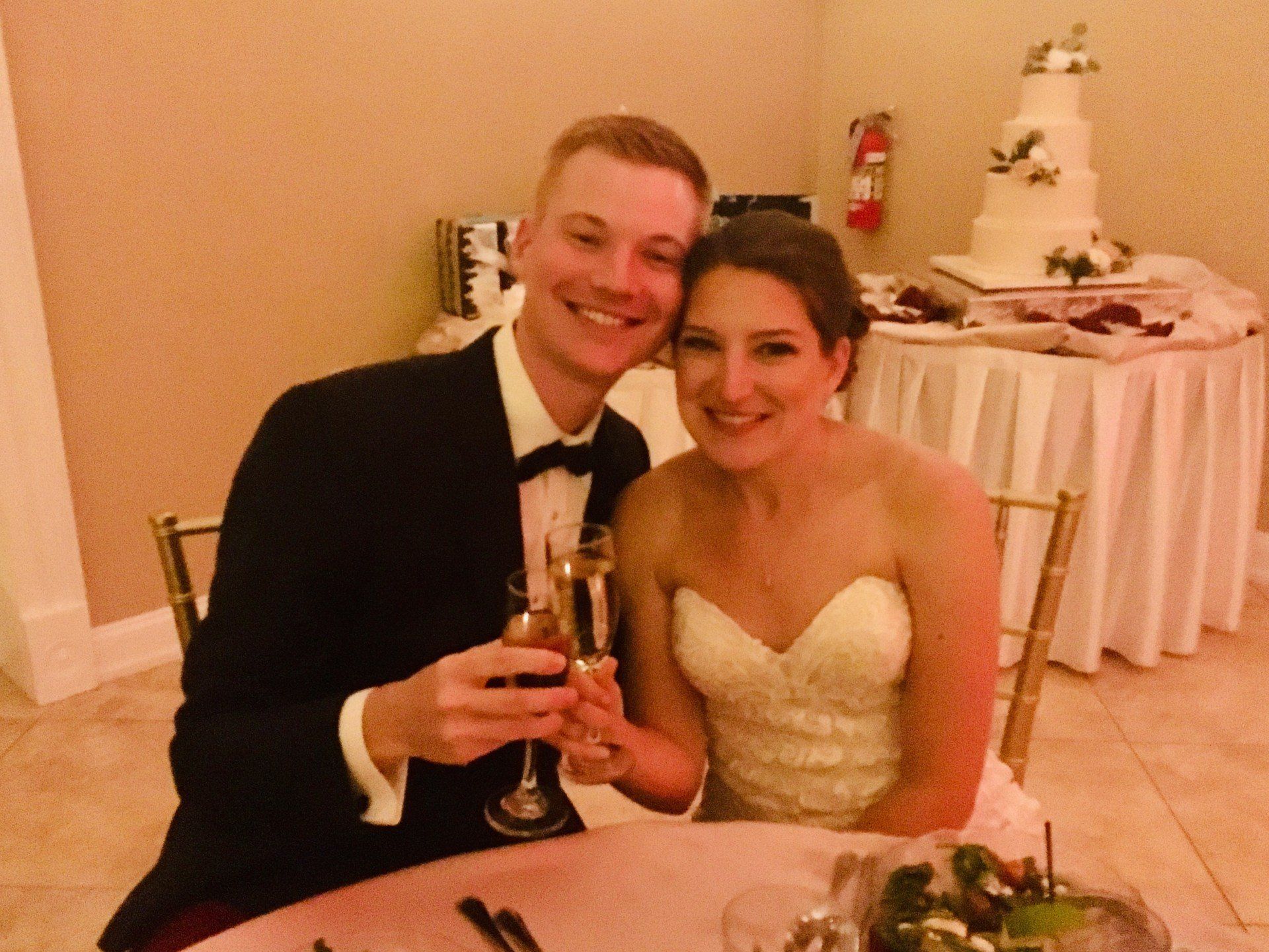 A bride and groom toasting with champagne at their wedding reception