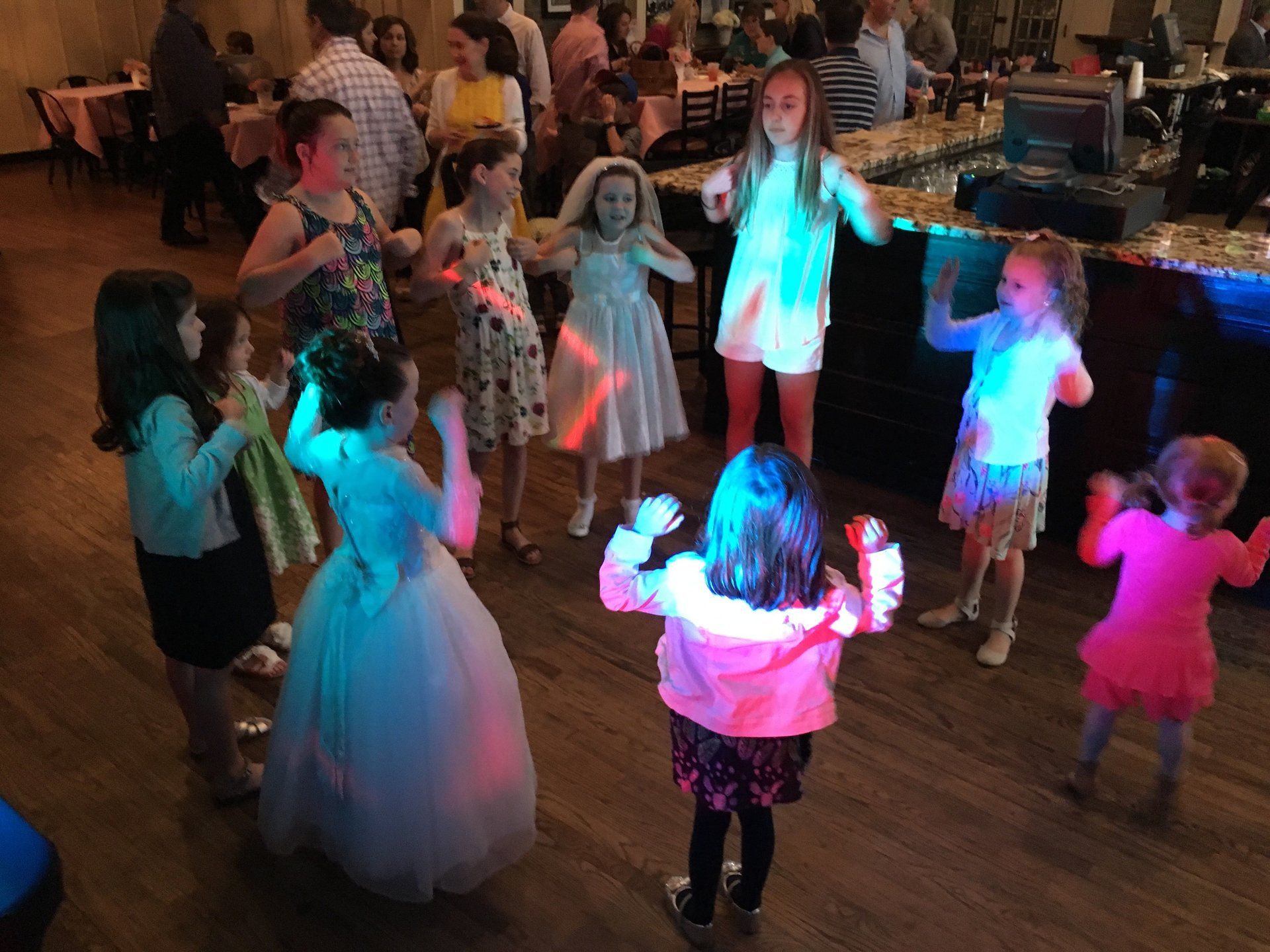 A group of young girls are dancing in a room.