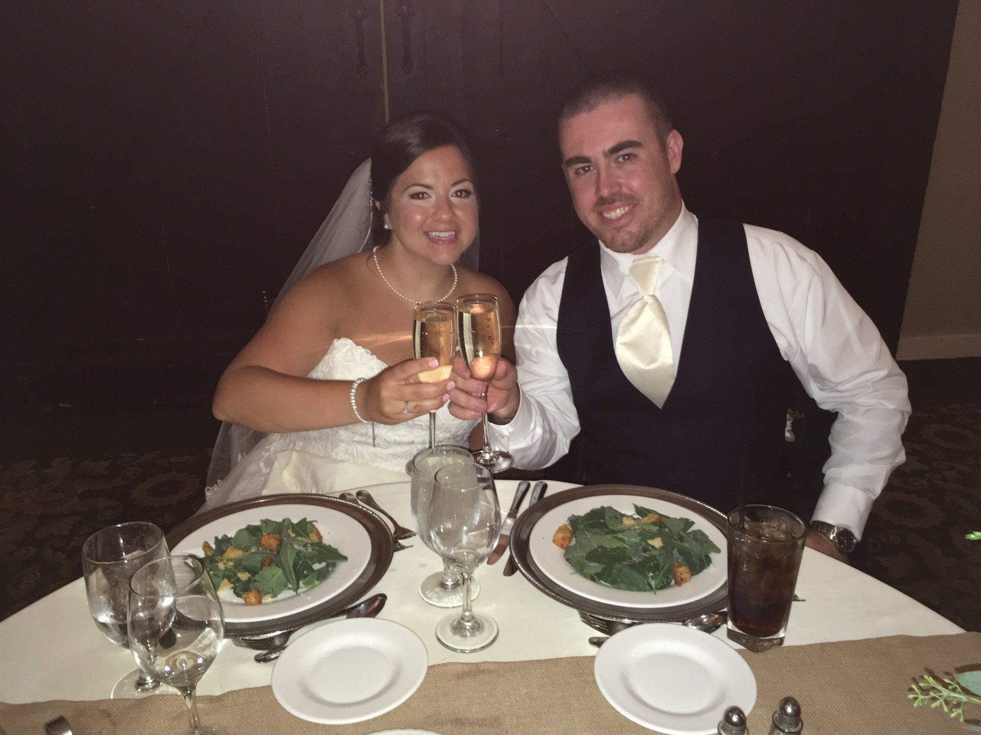 A bride and groom toasting with champagne at their wedding reception