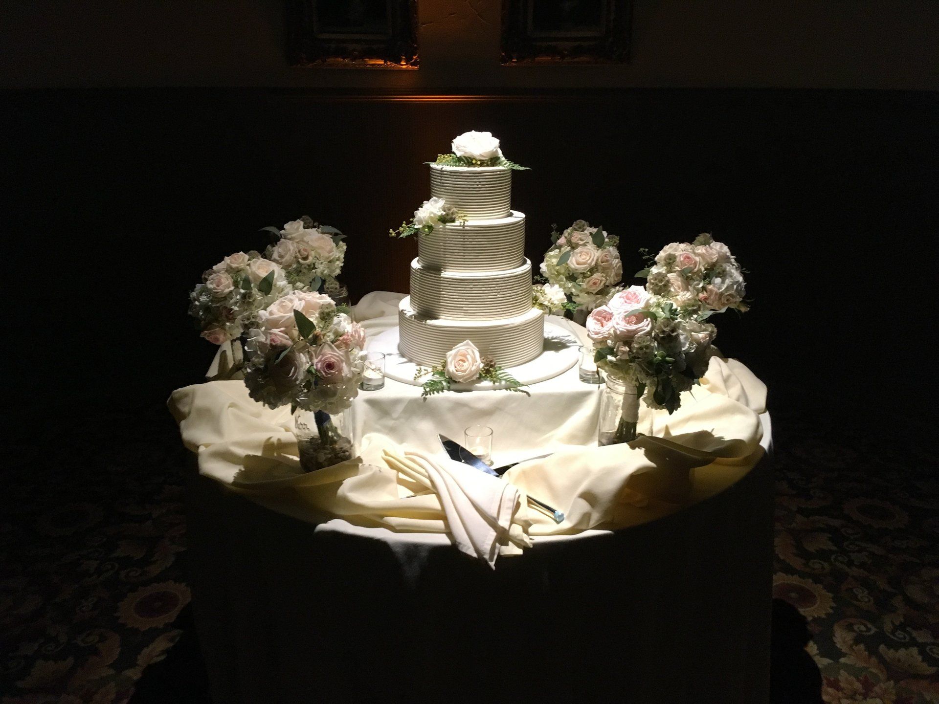 A wedding cake is sitting on a table with flowers