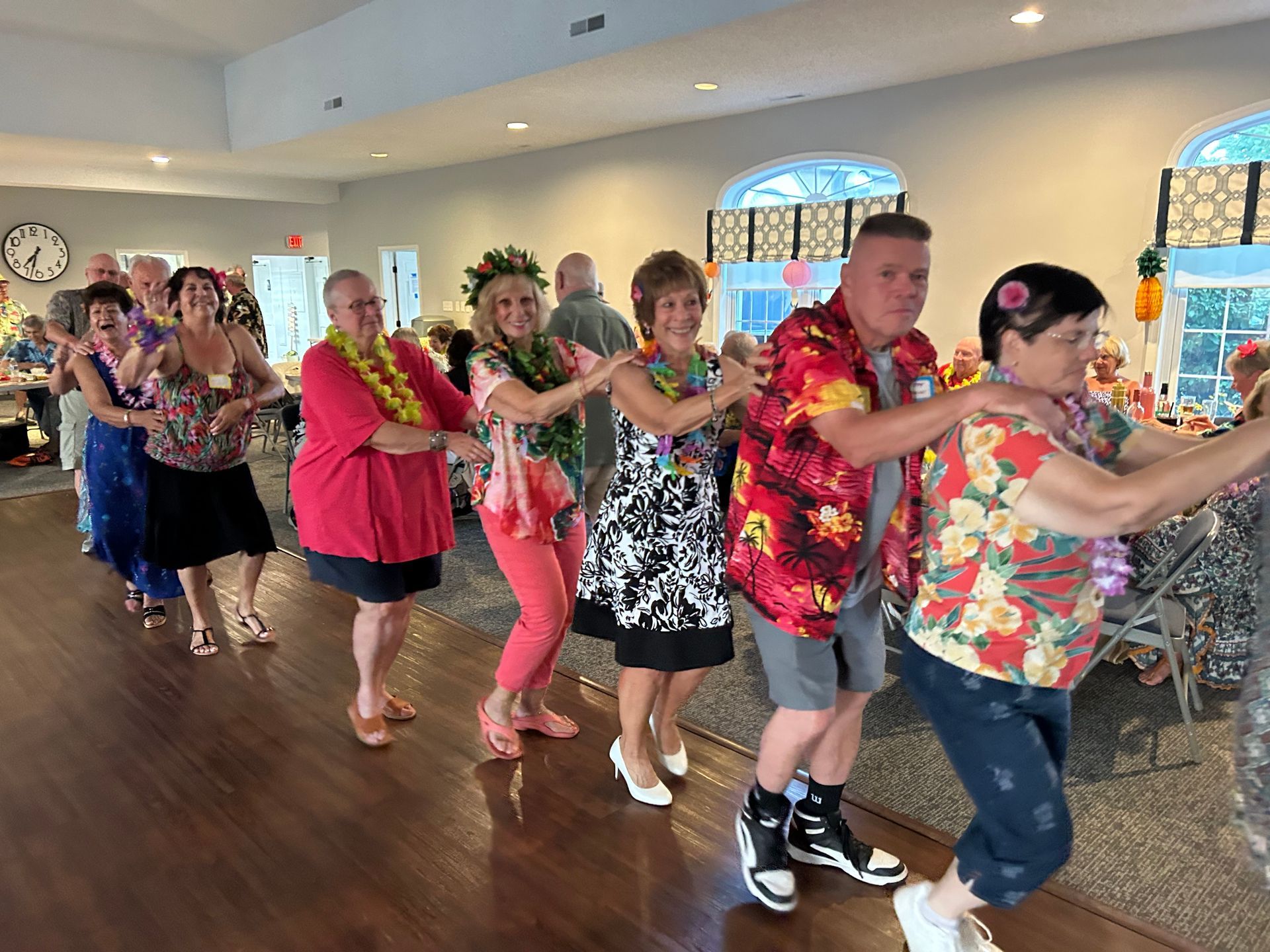 A group of people are dancing together in a room.