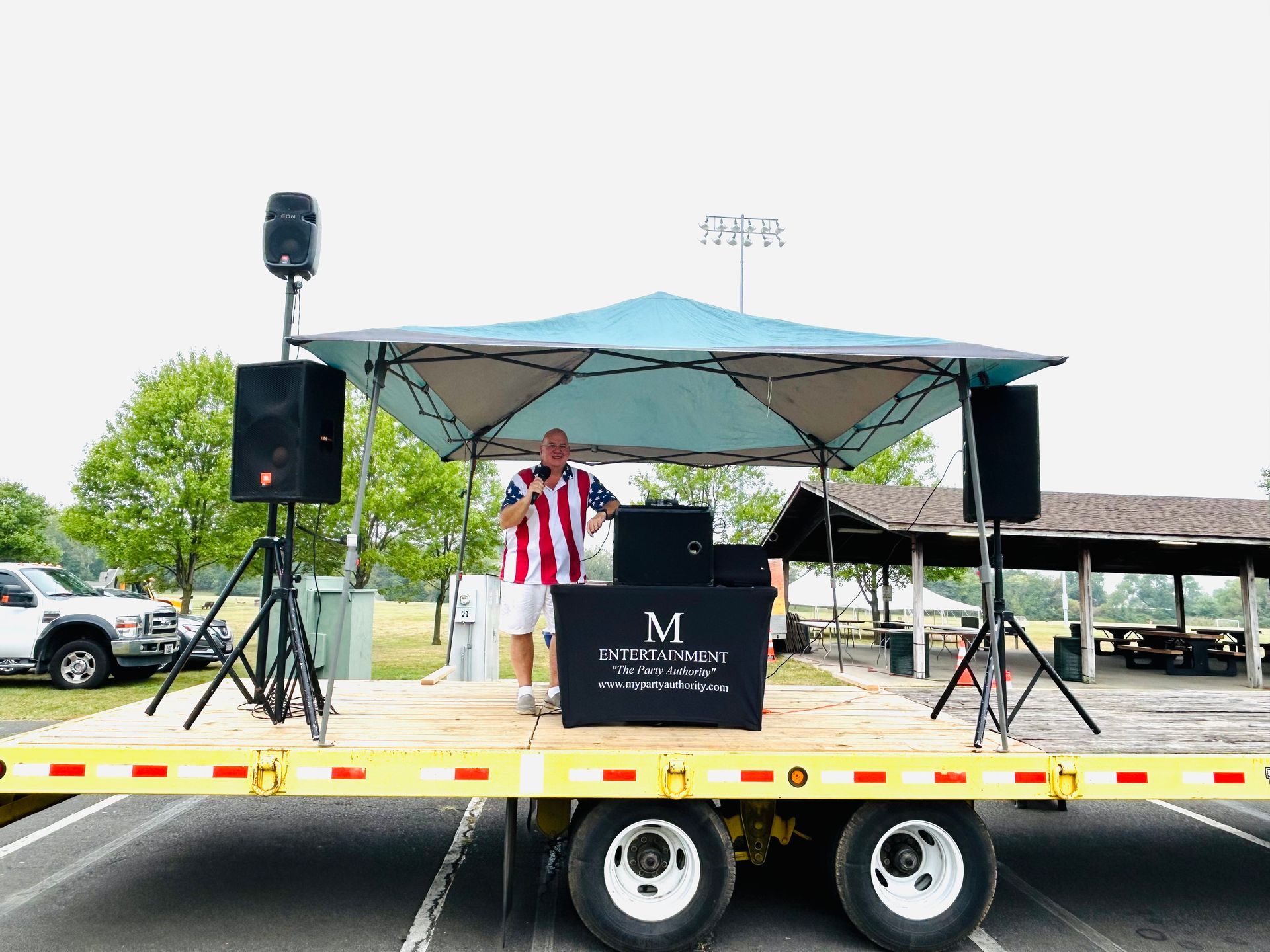 A man is standing on a stage on a trailer.
