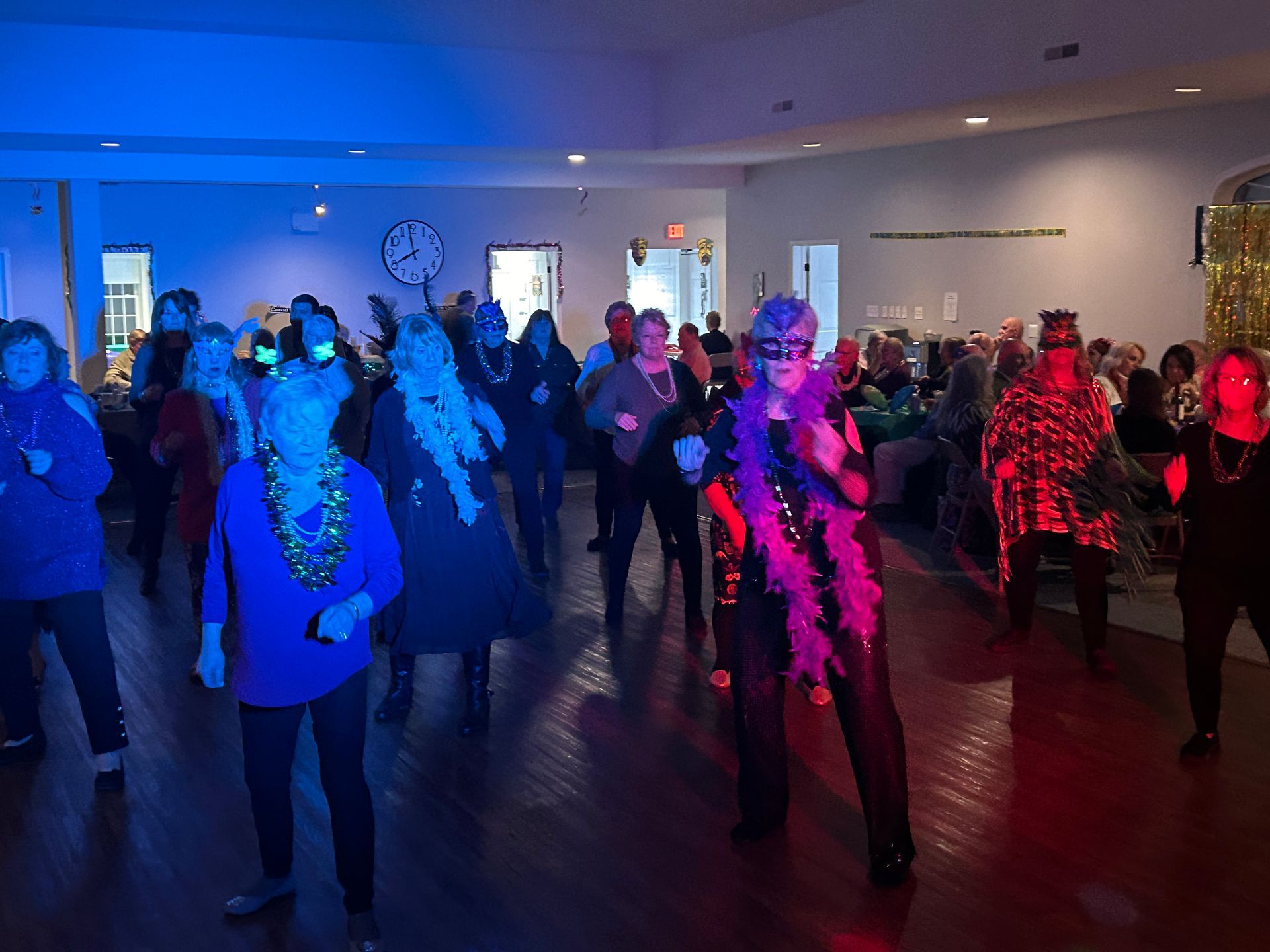 A group of people are dancing in a room.