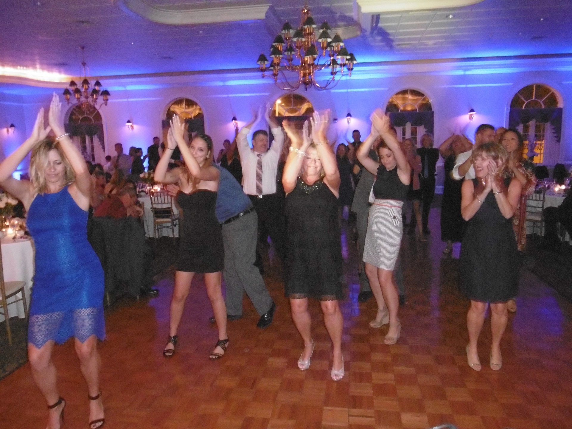 A group of people are dancing on a dance floor