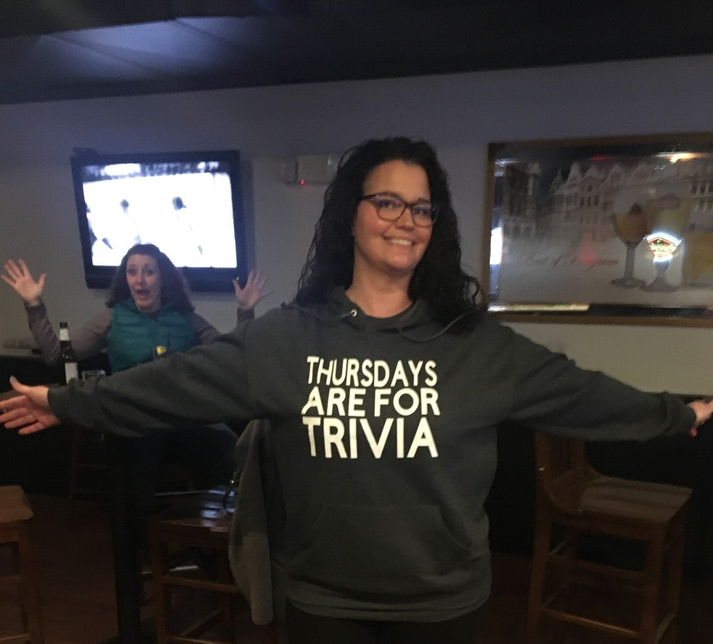 A woman wearing a shirt that says thursdays are for trivia