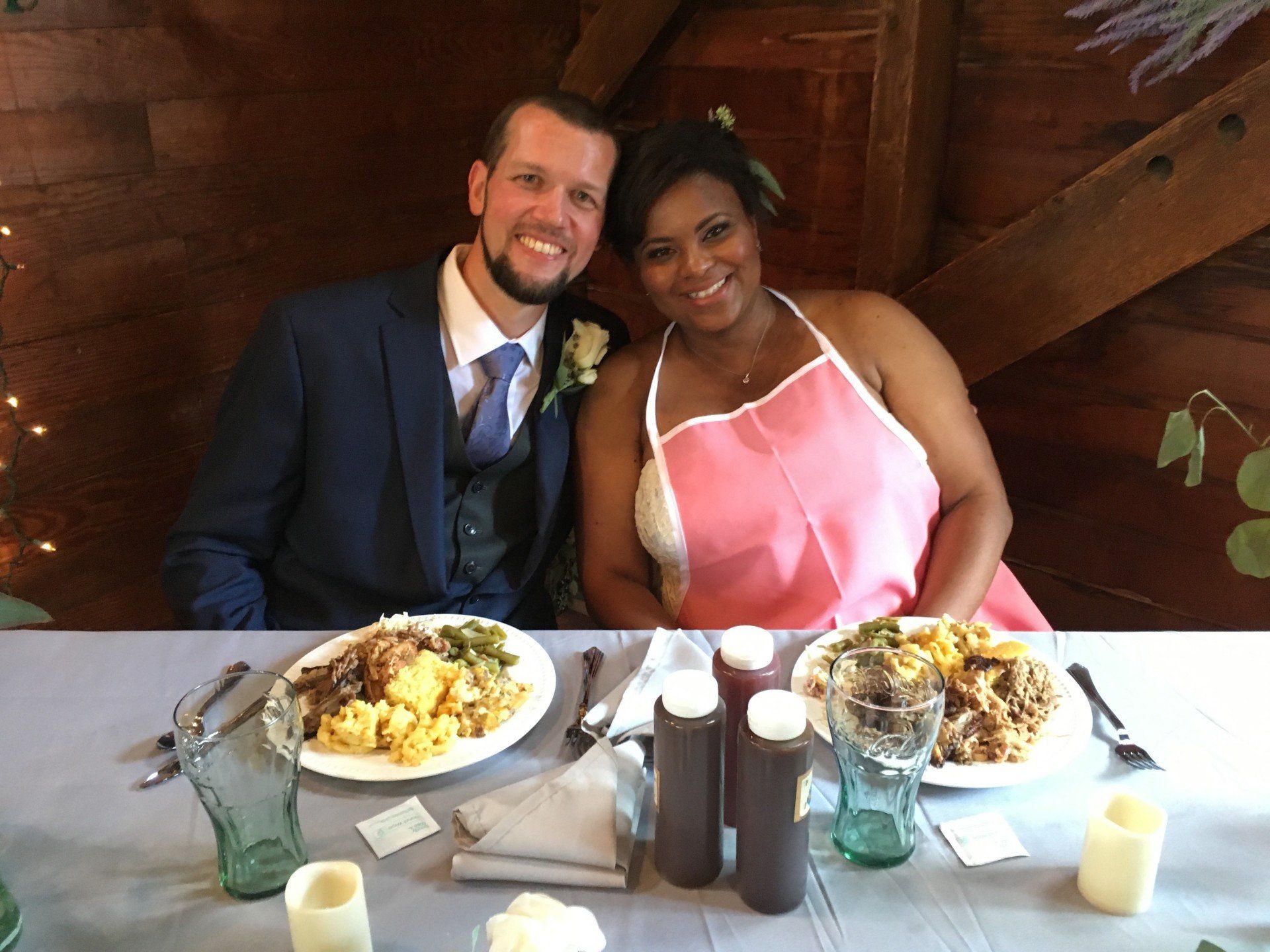 A man and a woman are sitting at a table with plates of food.