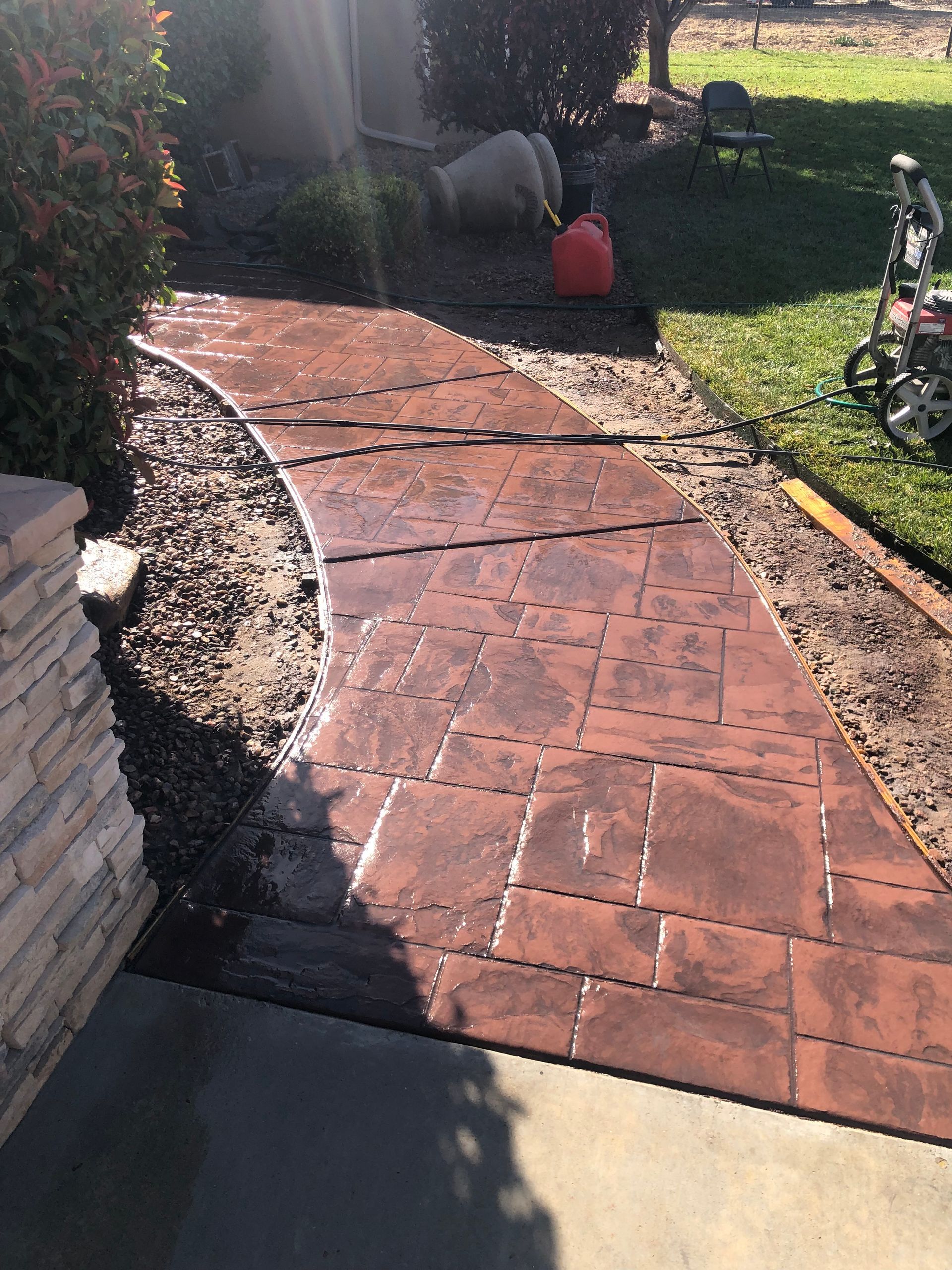 A close up of a brick walkway with a circular pattern.