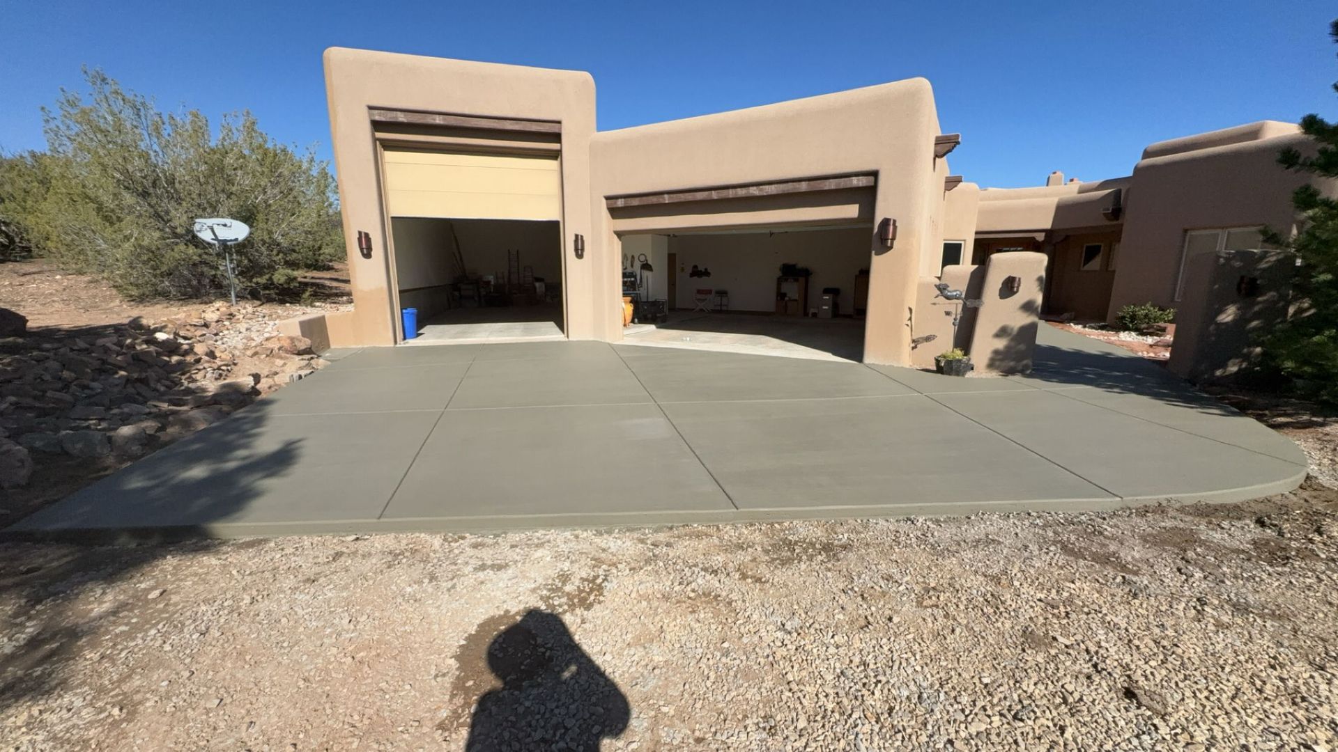 A large house with a concrete driveway in front of it.