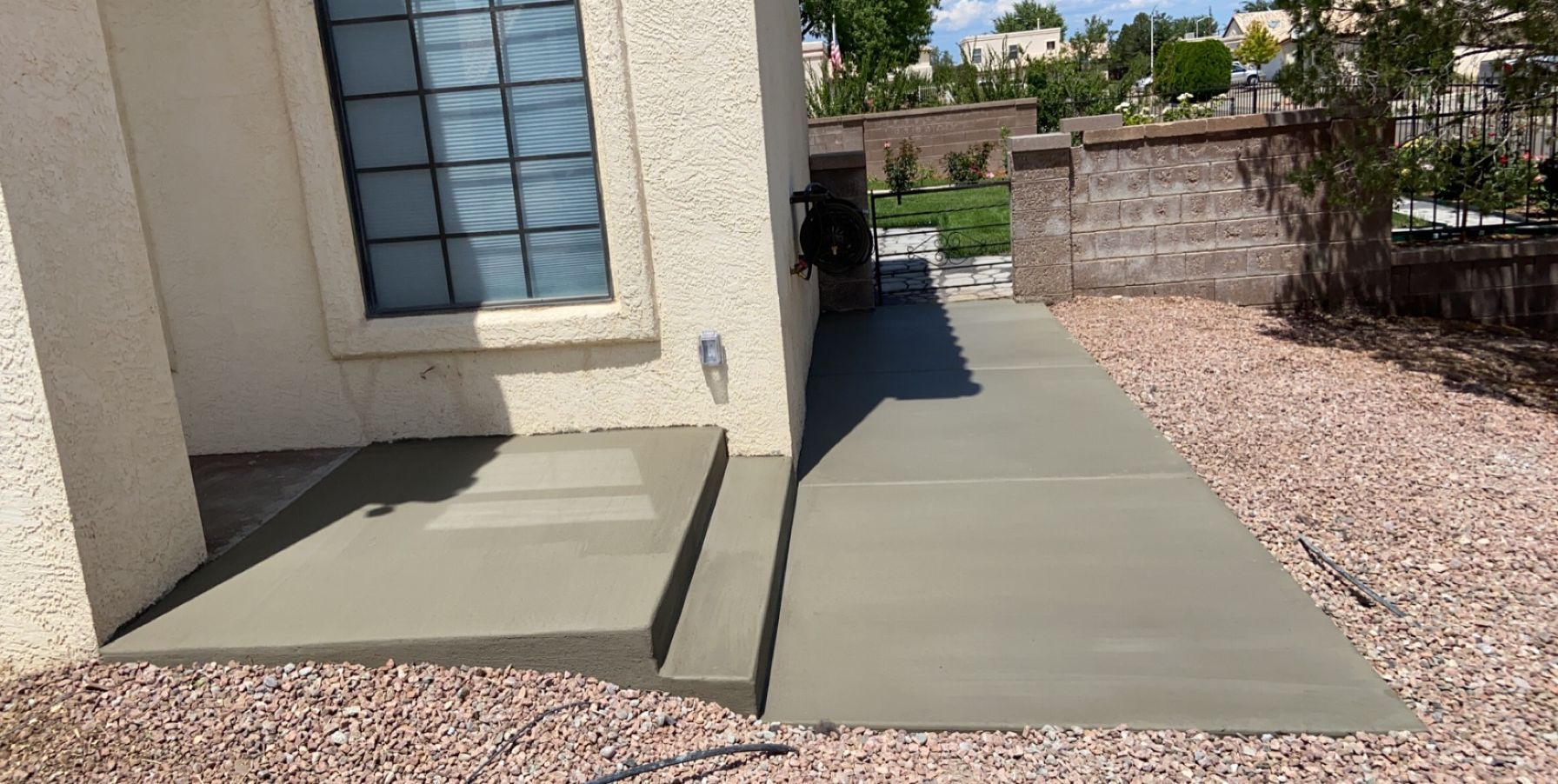 A concrete walkway is being built in front of a house.
