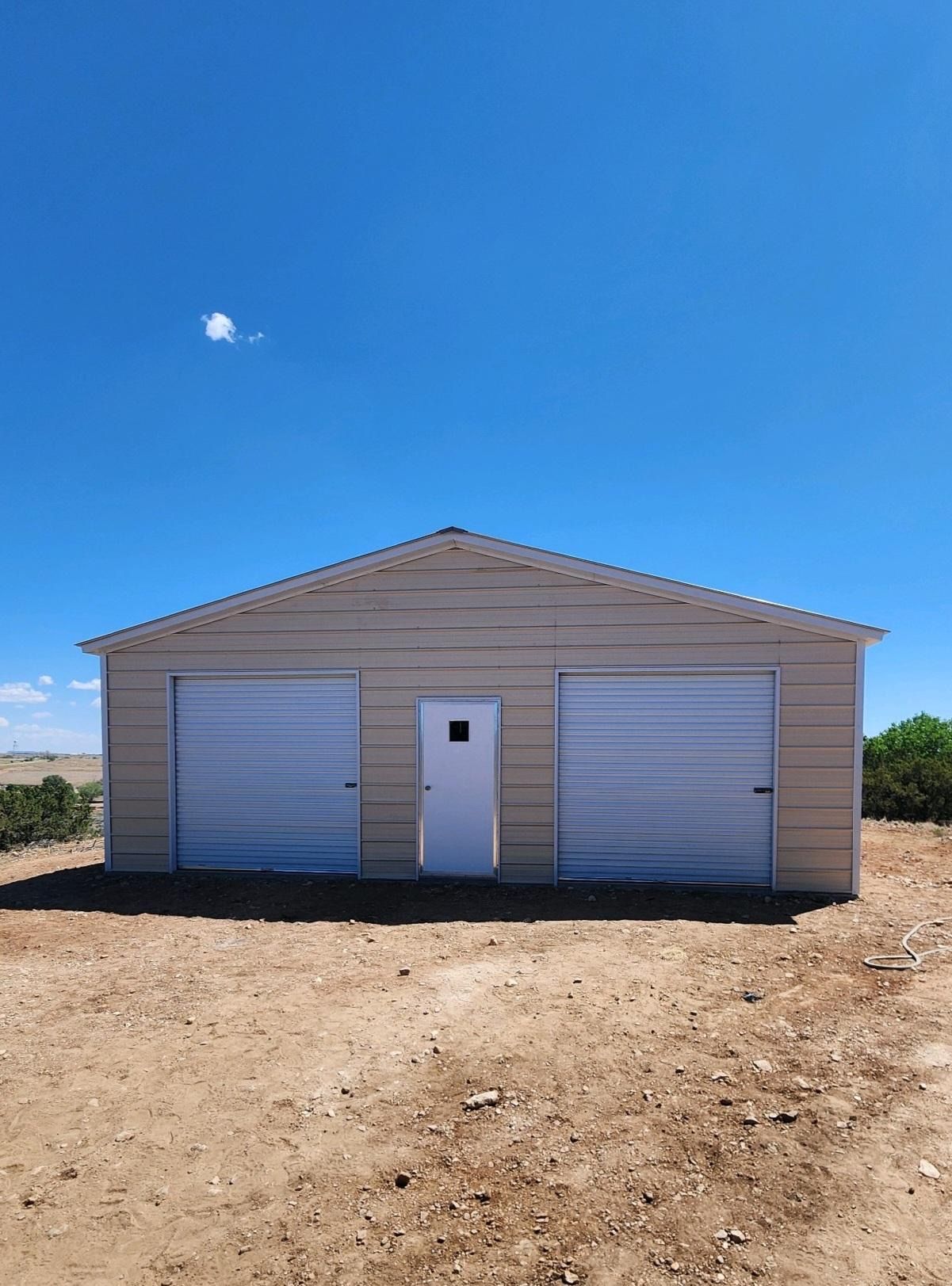 A white garage with a blue sky in the background