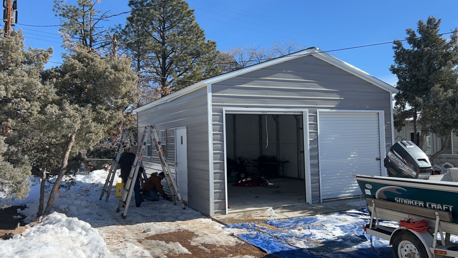 A boat is parked in front of a garage.
