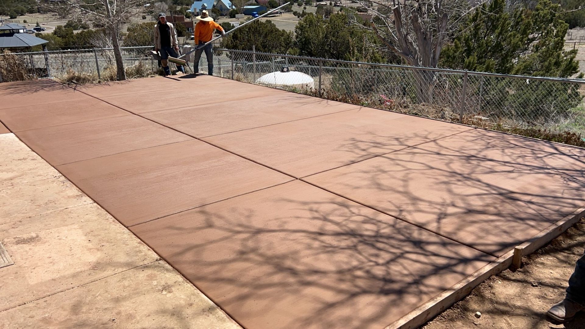A group of people are standing on top of a wooden deck.