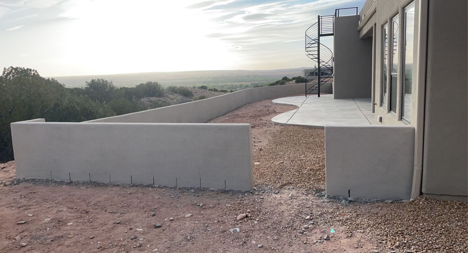 A house is being built on a hill with a view of the ocean.