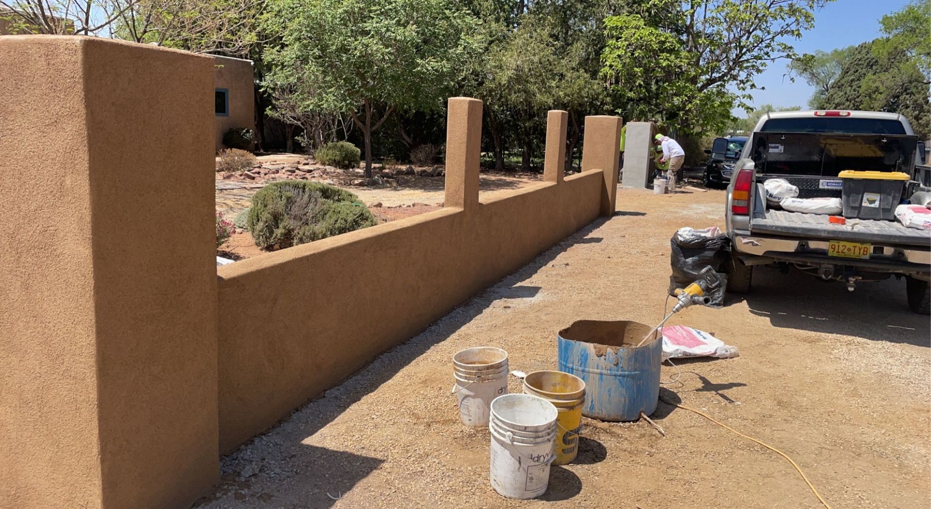 A curved brick wall is being built in the dirt.