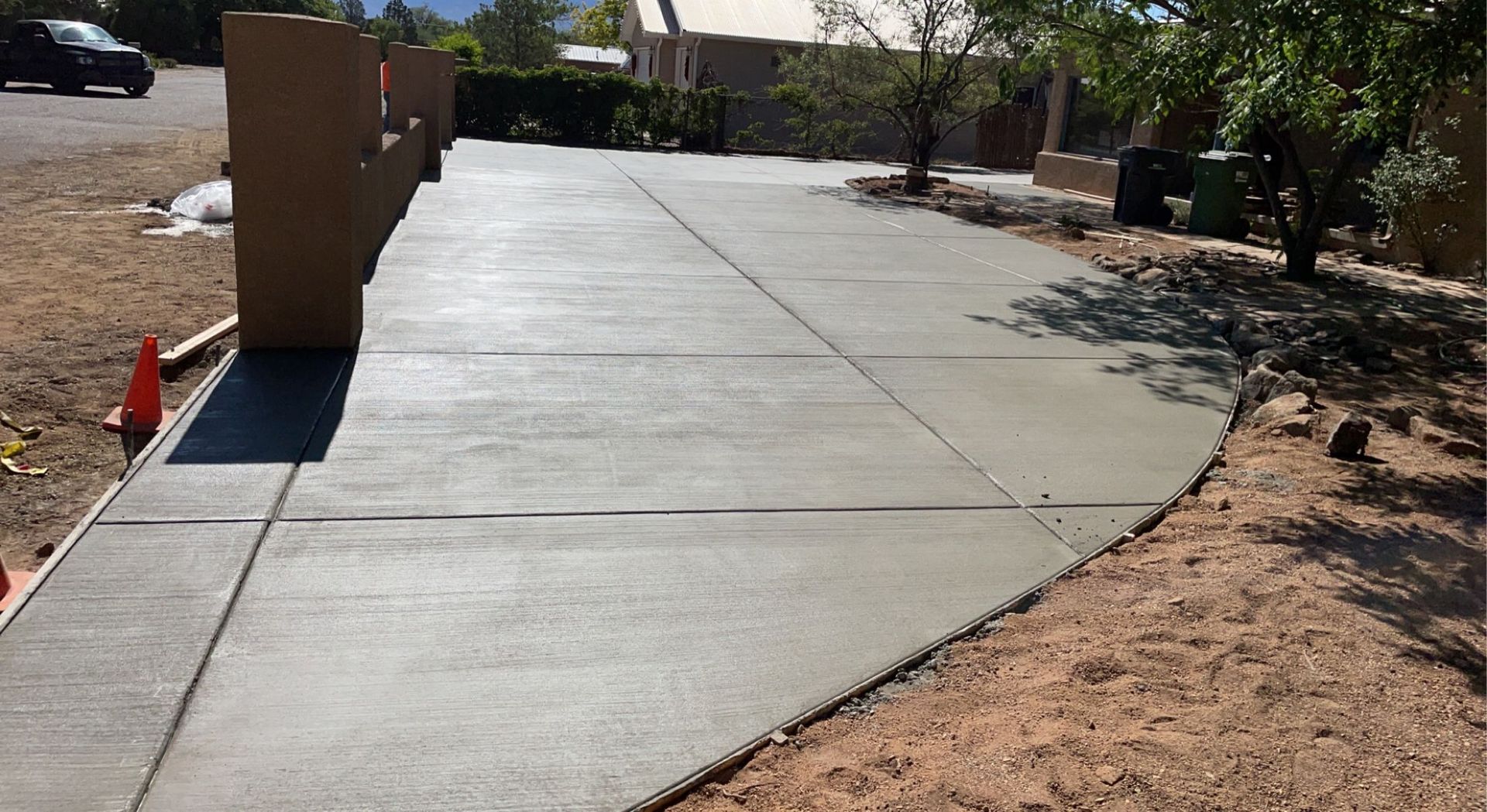 A concrete driveway is being built in front of a house.