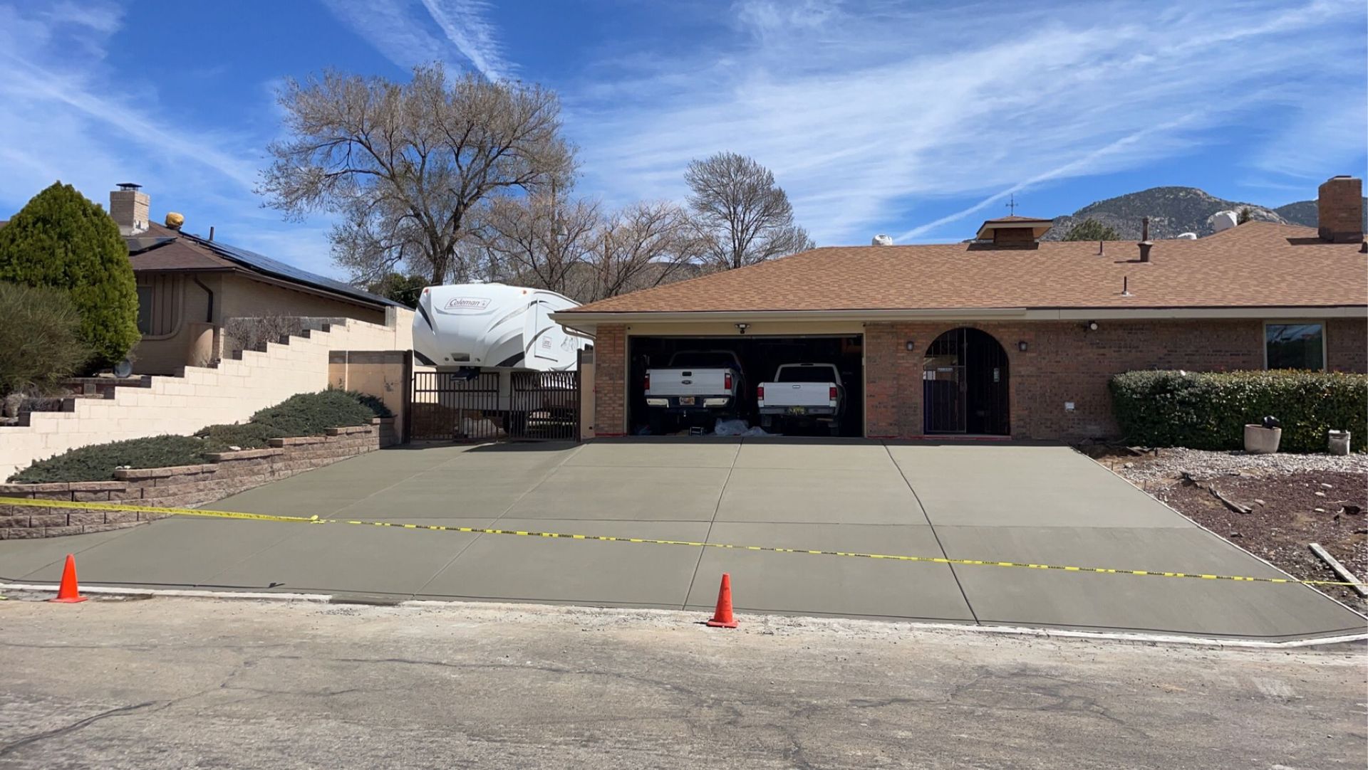 A house with a concrete driveway in front of it.
