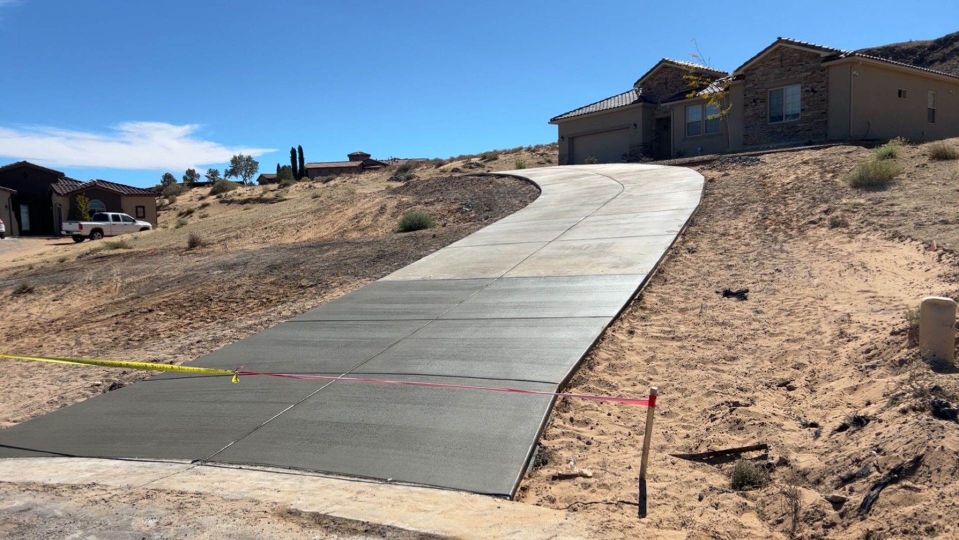 A concrete driveway is being built in front of a house.