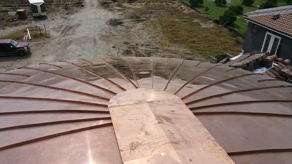 A copper roof is being built on top of a building