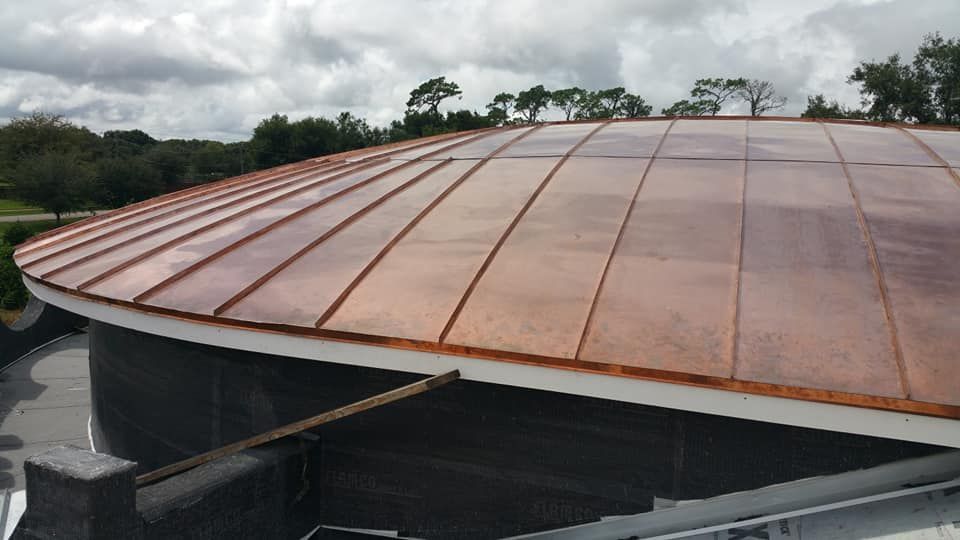 A copper roof is being installed on a building