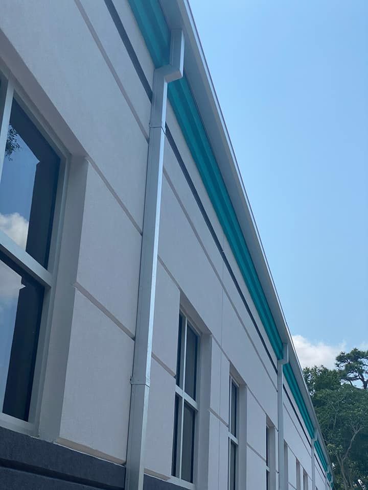 A building with a gutter on the side of it.