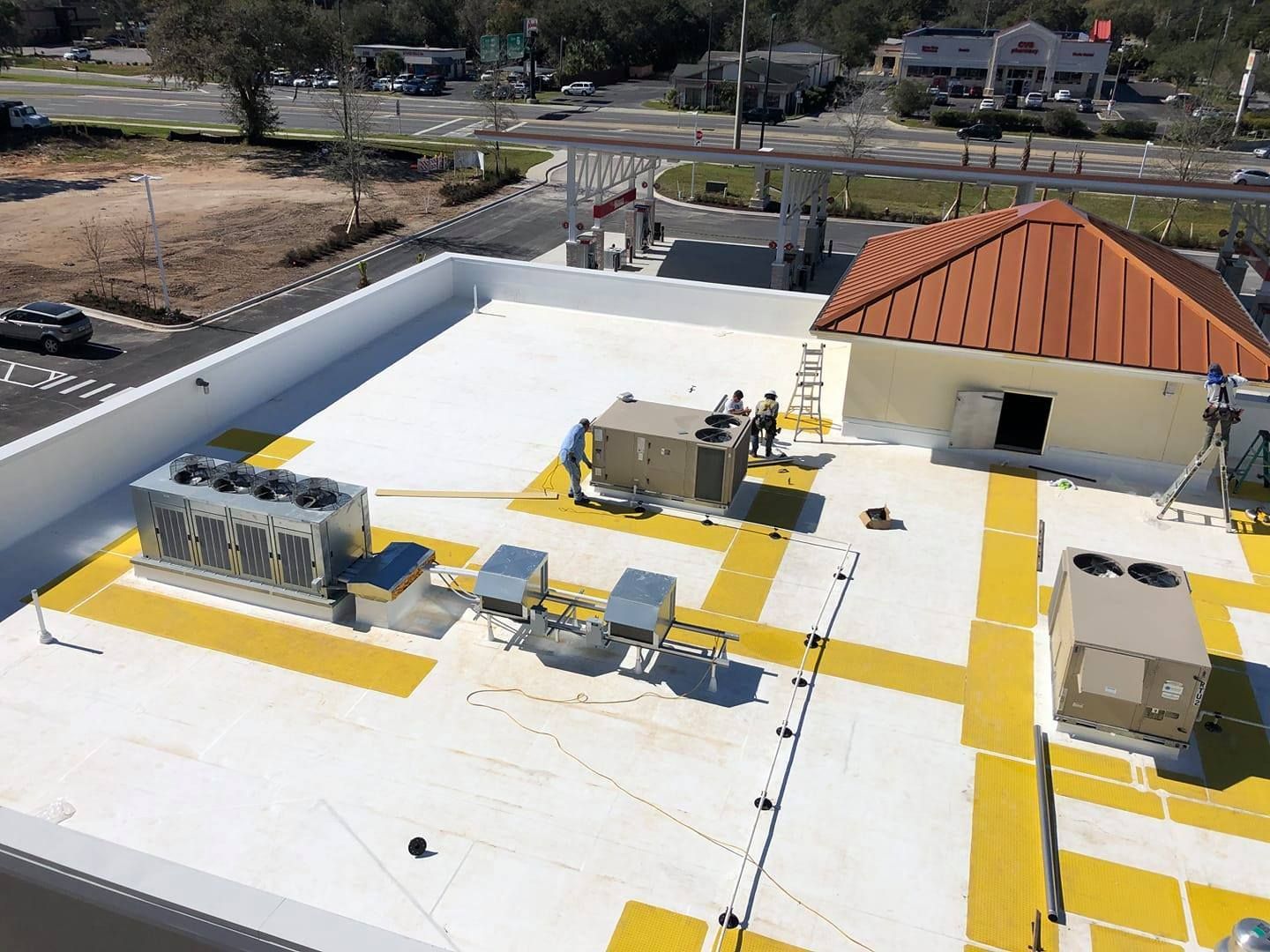 An aerial view of a white and yellow roof with a red roof.