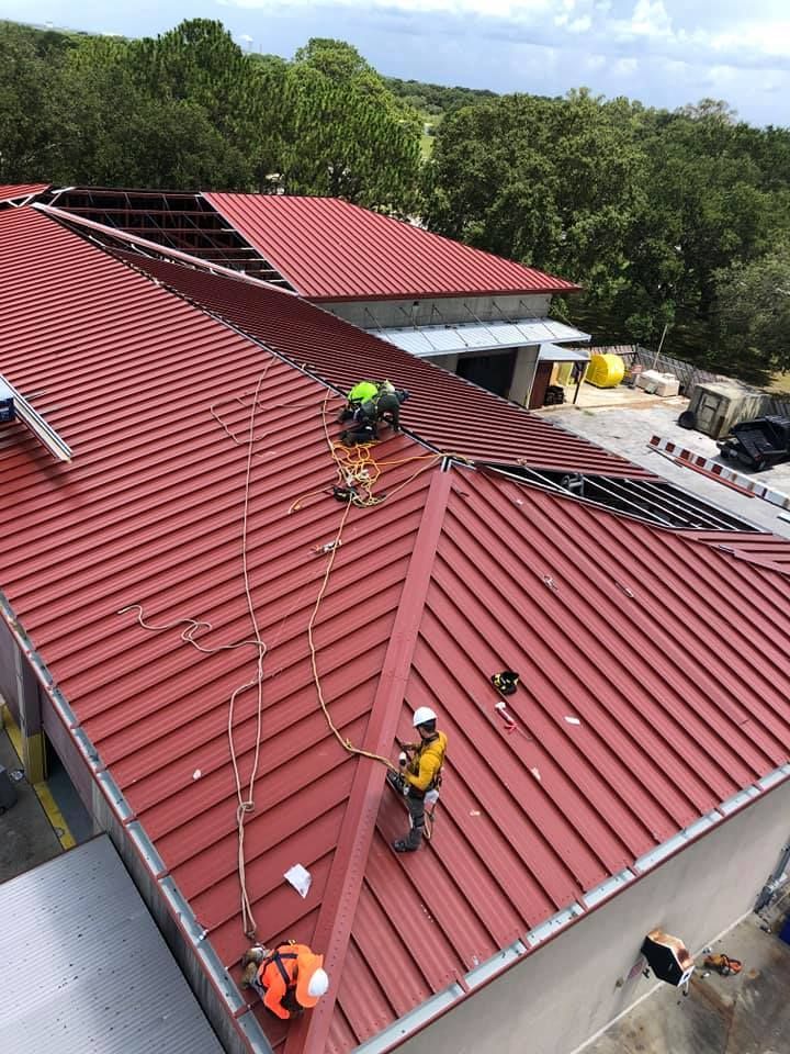 A group of men are working on the roof of a building.