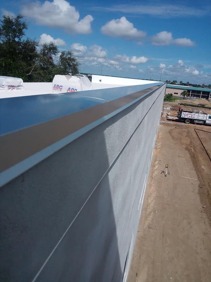 A large building under construction with a roof that says abc on it