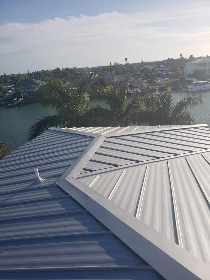 A close up of a roof with a view of a body of water.