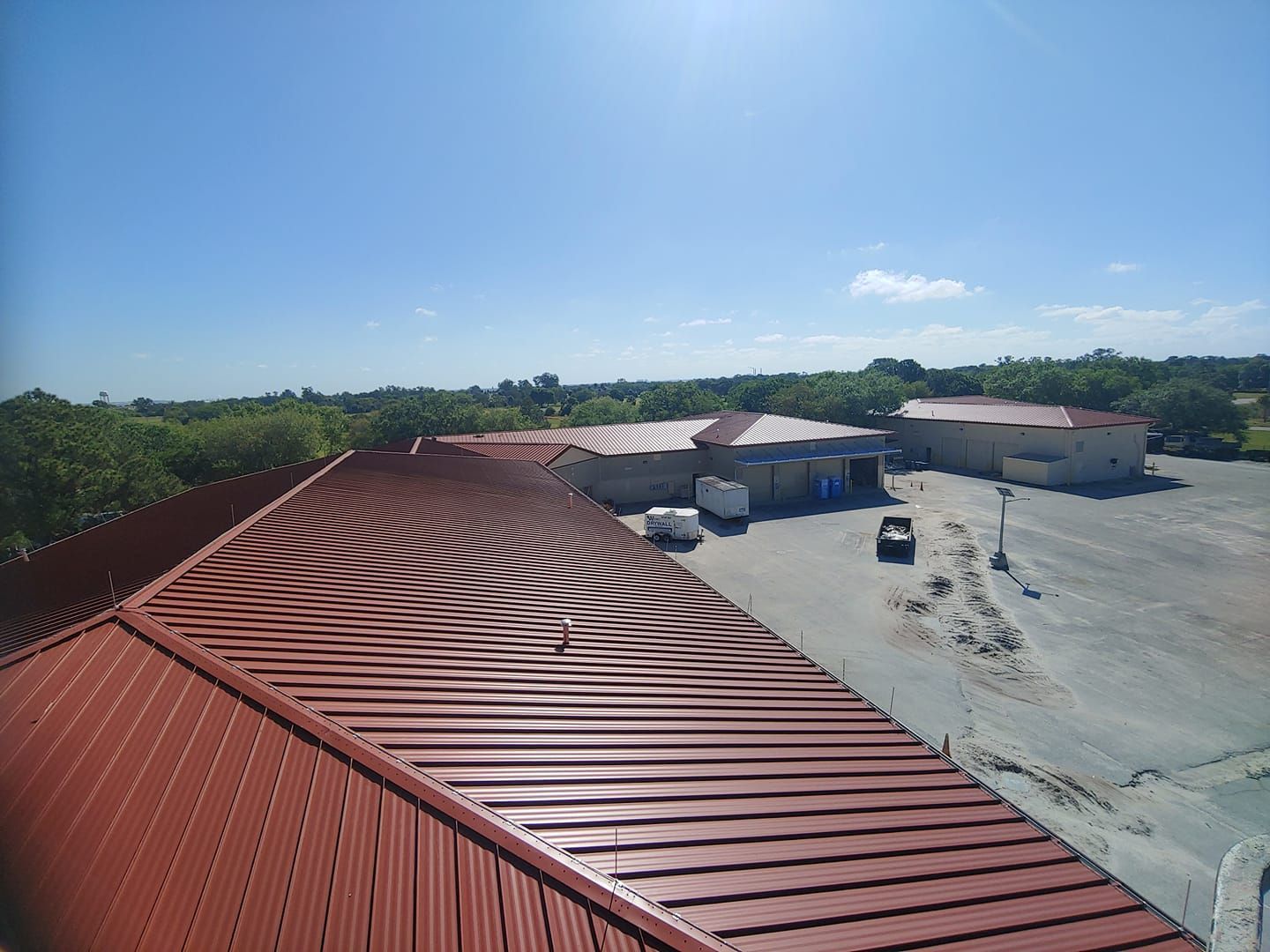 An aerial view of a building with a red roof