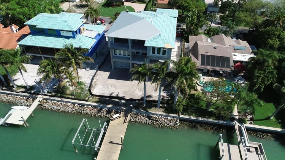 An aerial view of a row of houses next to a body of water