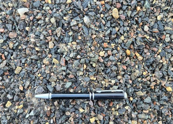 Black fountain pen on gravel, silver cap and trim.