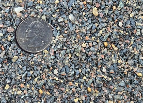 Penny lying on gray gravel stones