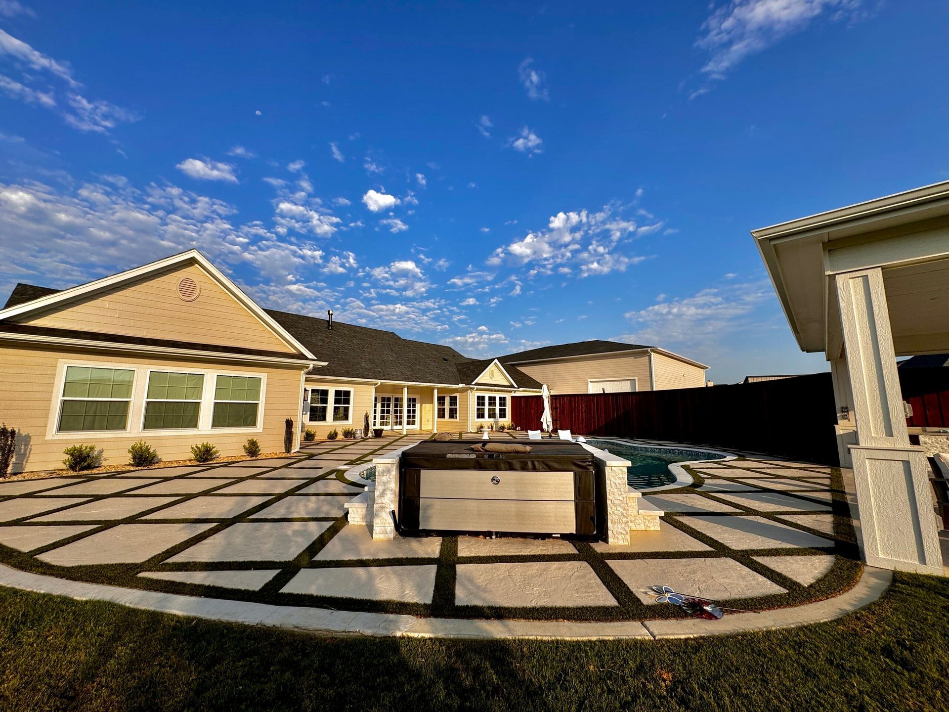 A large house with a large patio in front of it.