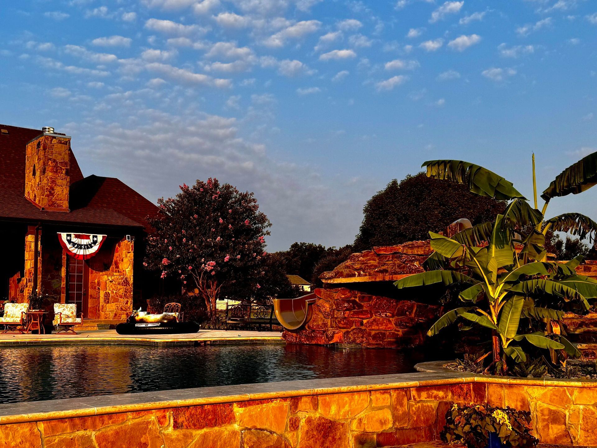 A large house with a swimming pool in front of it